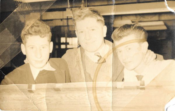 Old yellowed photograph of 3 schoolboys with tape marks and coffee stain