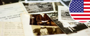 Lots of old photos and genealogy documents scattered across a table