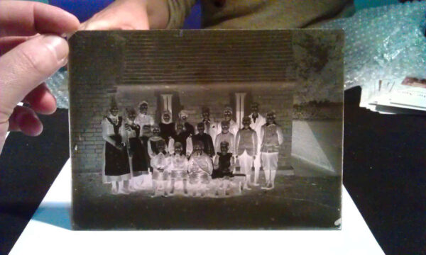 Old glass negative showing negative image of Victorian school children
