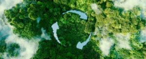 Recycle symbol in a birdseye view of a rainforest
